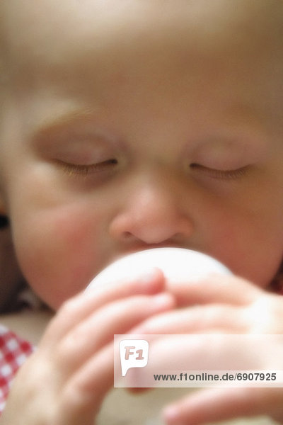 Close-Up of Baby Drinking from Bottle