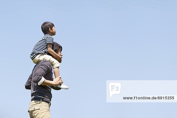 Father Carrying Son on Shoulders