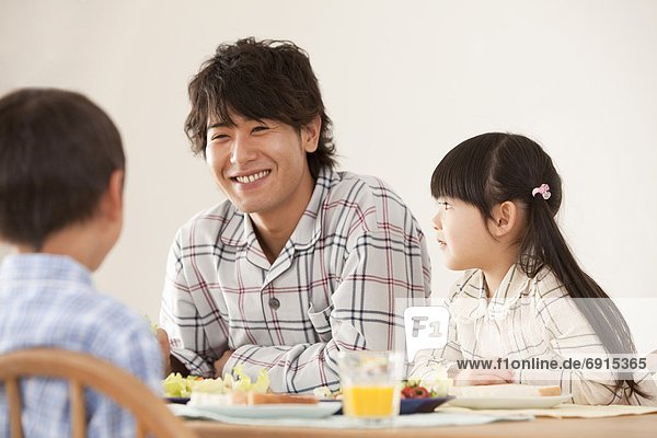 Father with Two Children at Breakfast Table