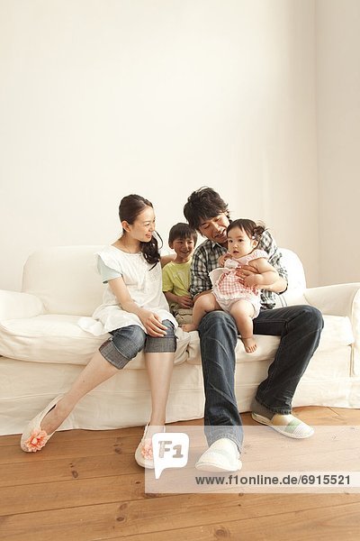 Mother  Father and Two Children on Sofa