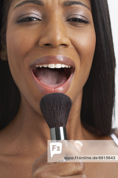 Woman Singing into Make-Up Brush