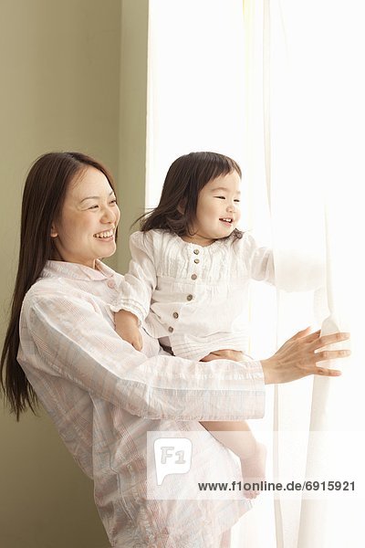 Mother and Daughter Looking Through Window