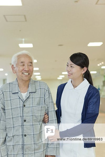 Nurse supporting a senior man  Kanagawa Prefecture  Honshu  Japan