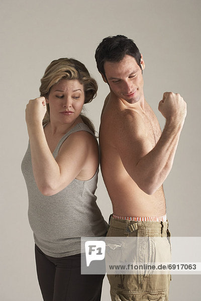Portrait of Couple Flexing Their Arms