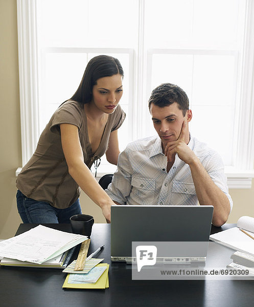Couple Paying Bills Online