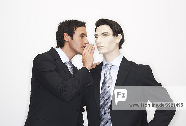 Businessman Whispering To Mannequin