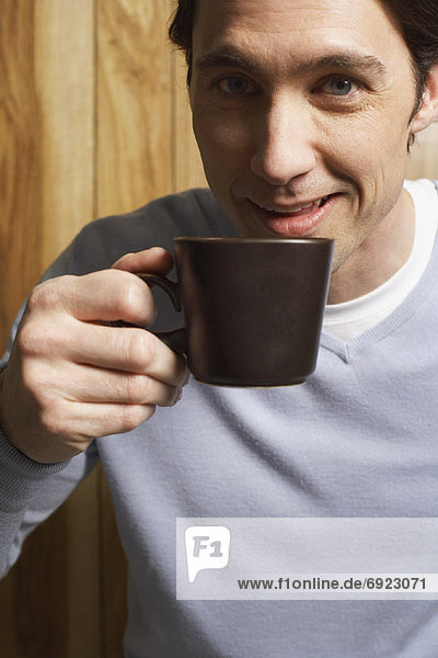 Man Drinking Cup of Coffee