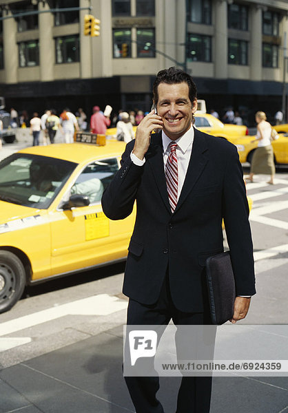 Businessman outdoors  Talking On Cellular Phone