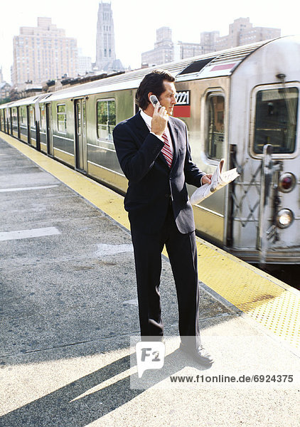 Businessman on Subway Platform  Talking on Cellular Phone