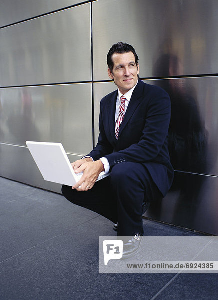Businessman with Laptop Outdoors