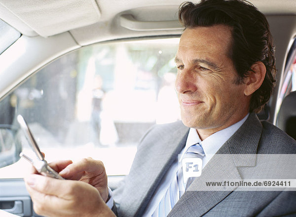 Businessman in Car  Using Cell Phone