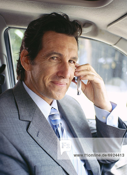 Businessman in Car  Using Cell Phone