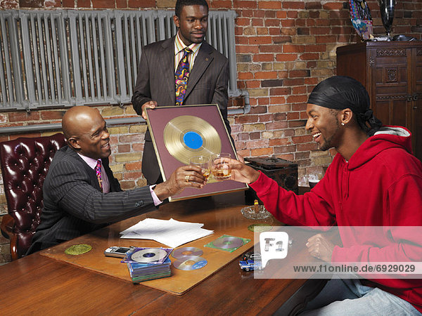 Record Executives Presenting Gold Record to Hip Hop Artist