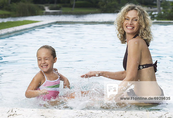 Mother and Daughter Playing in Swimming Pool