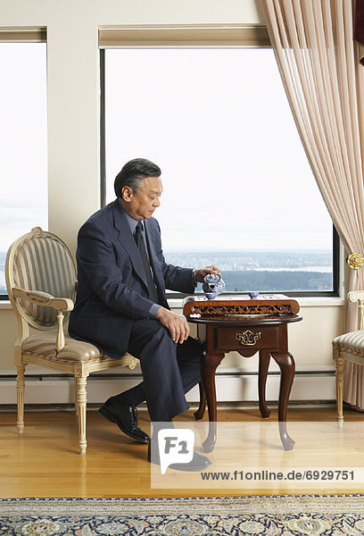 Man Pouring Tea in Elegant Home