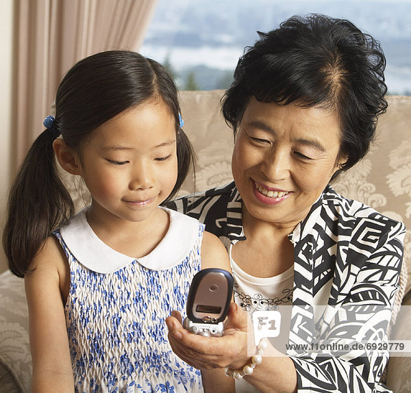 Grandmother and Granddaughter with Cell Phone