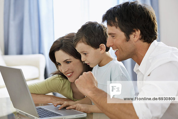 Young Family with Laptop Computer