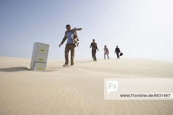 Business People and Filing Cabinet in Desert