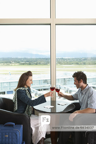 Couple Toasting in Airport  Vancouver  British Columbia  Canada