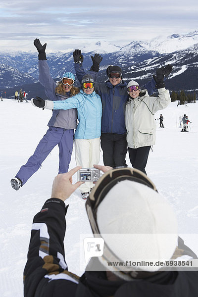 Person Taking Picture of Friends On Ski Hill  Whistler  BC  Canada