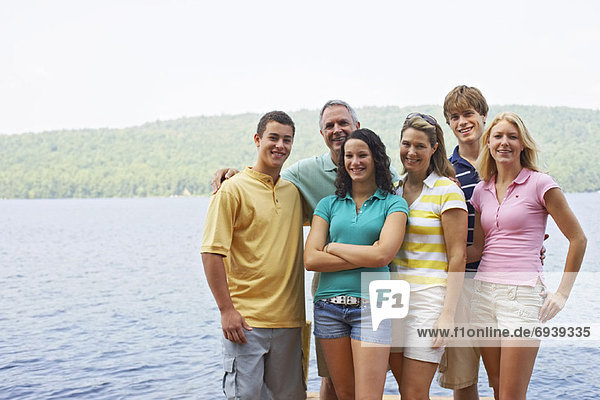 Family Standing on Dock  Belgrade Lakes  Maine  USA