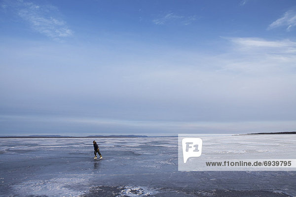 Boy Skating on Frozen Lake