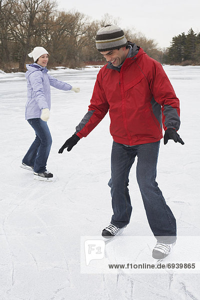 Woman with Man Learning to Skate