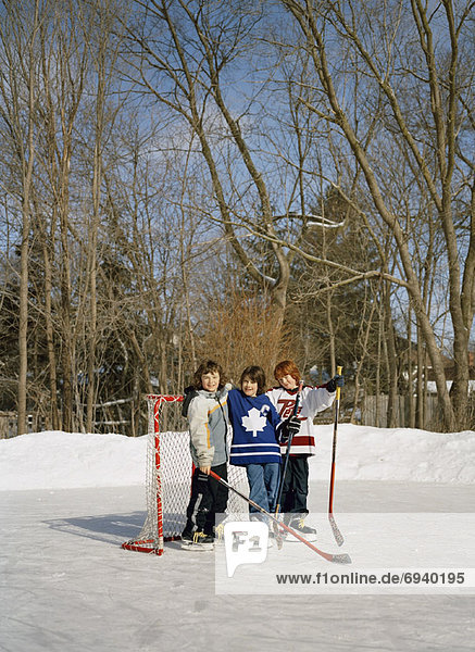 Friends on Backyard Hockey Rink