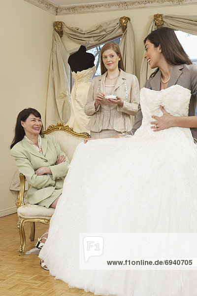 Saleswoman and Clients in Bridal Boutique