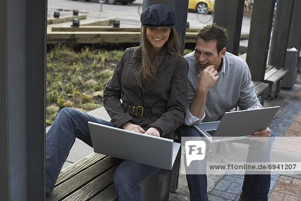 Portrait of Couple with Laptops