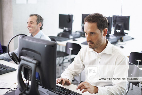 Men Working on Computers in Office