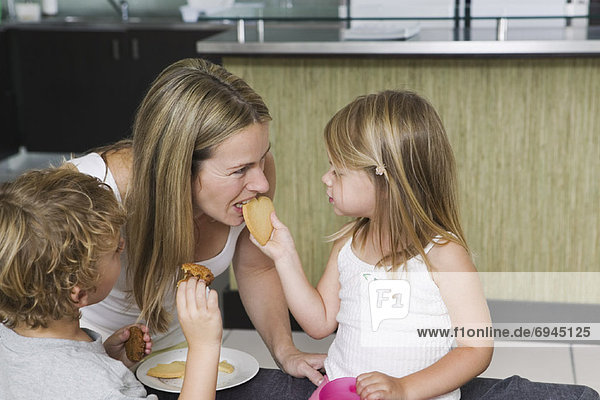 Mother and Children Eating Cookies