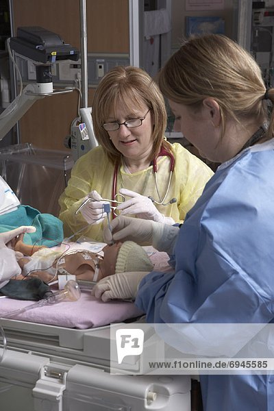Nurses Practicing with Baby Mannequin