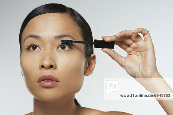 Portrait of Woman Applying Makeup
