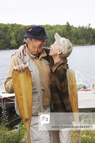 Couple by Dock with Canoe Paddles