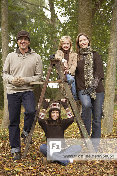 Portrait of Family in Park in Autumn