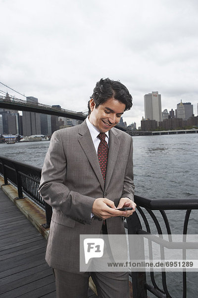 Businessman by Brooklyn Bridge  New York City  New York  USA