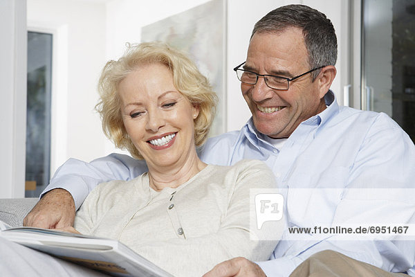 Couple on Sofa with Book
