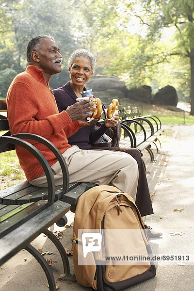 Couple with Coffee and Pretzels in City Park  New York City  New York  USA