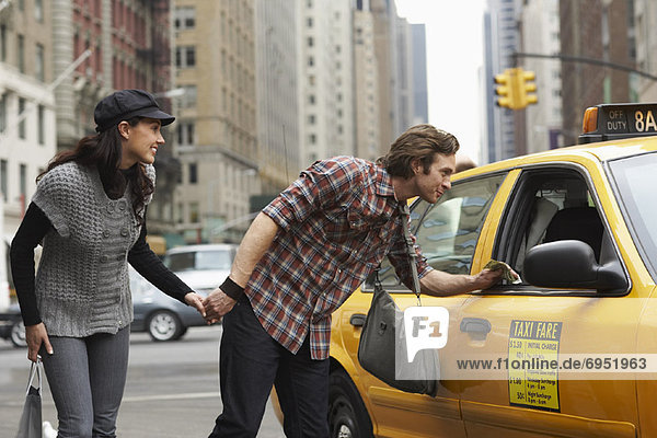 Couple Hailing Taxi Cab  New York City  New York  USA