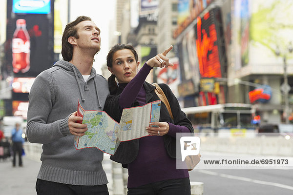 Couple in City with Map  New York City  New York  USA
