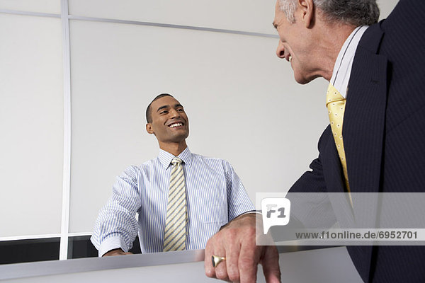 Receptionist and Businessman at Desk