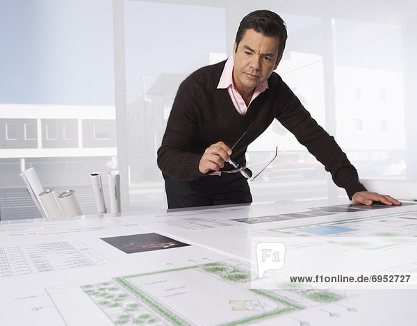 Architect Looking over Blueprint