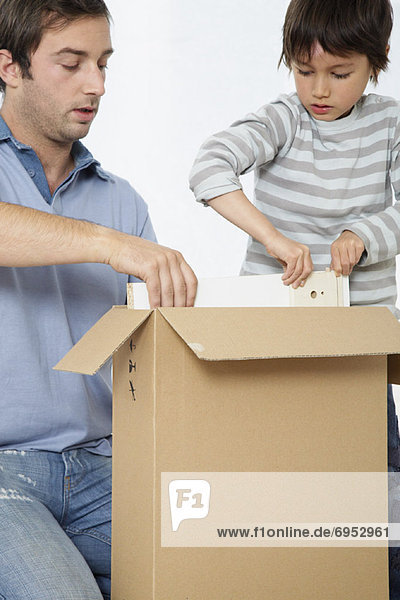 Father and Son Looking through Box