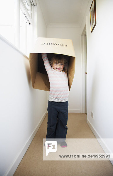 Girl Playing with Cardboard Box