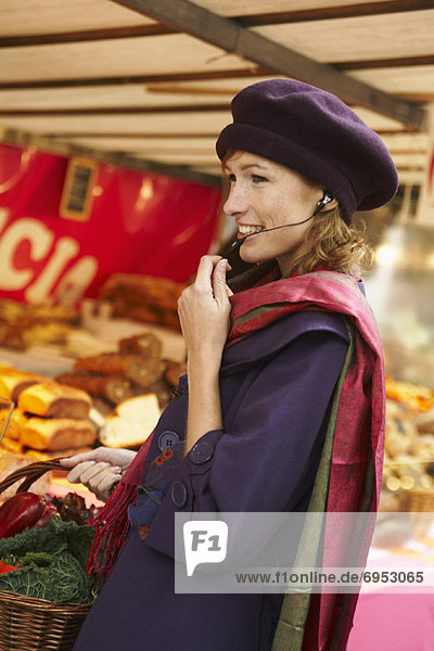 Woman Wearing Hands Free Headset at Market