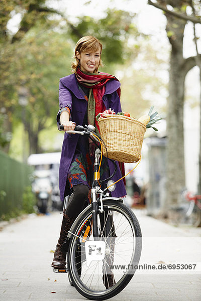 Woman Riding Bicycle on Sidewalk