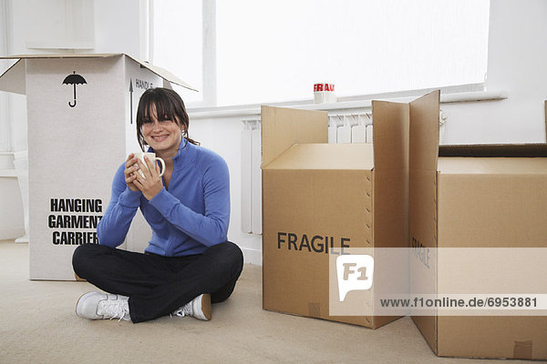 Woman with Moving Boxes in Room