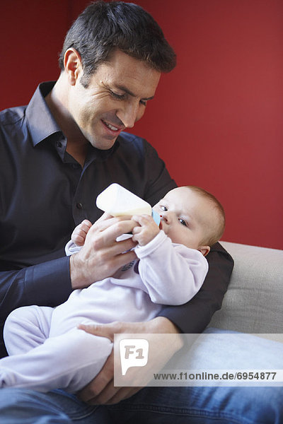 Father Feeding Baby with Bottle