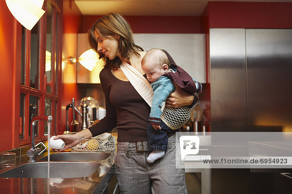Woman with Baby in Kitchen